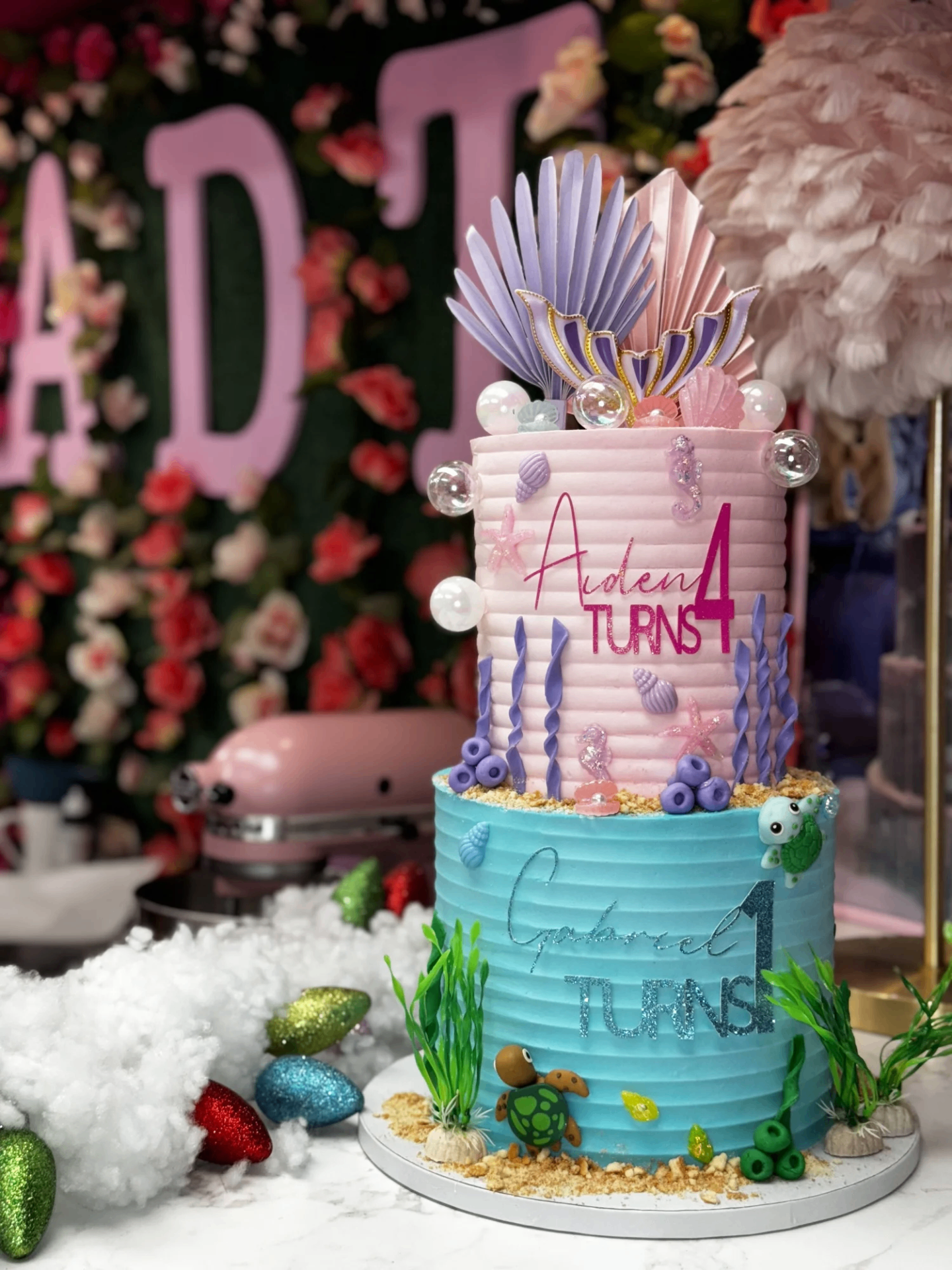 Two-tier under-the-sea mermaid birthday cake with pink and teal buttercream