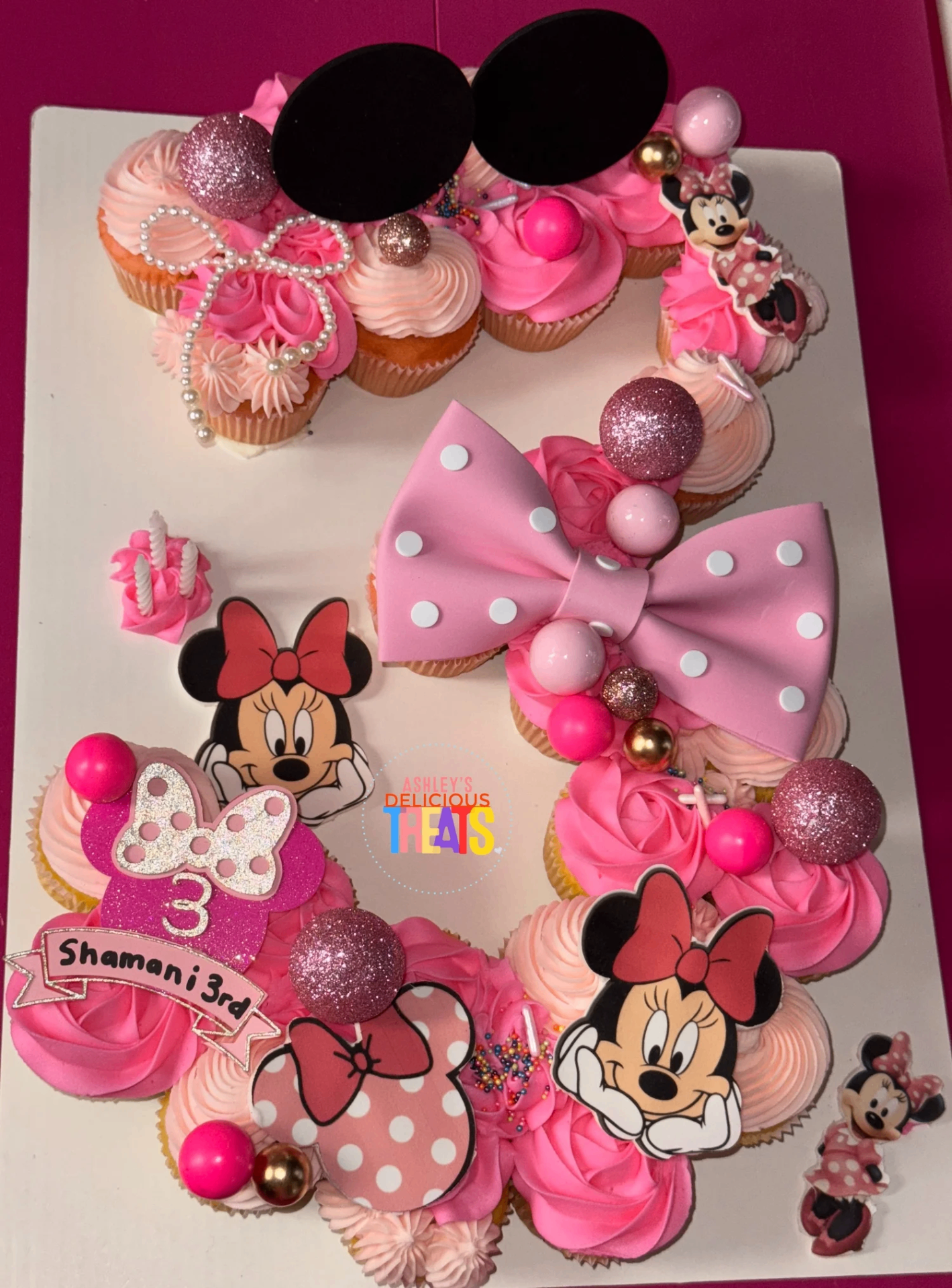 Pink Minnie Mouse number-three cupcake cake with bow and themed toppers